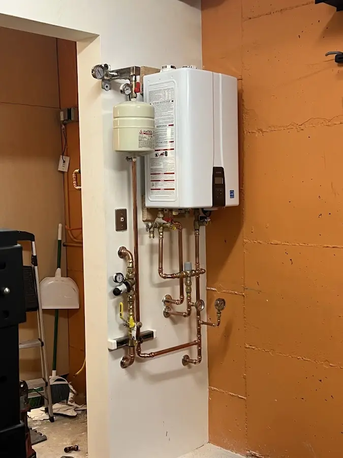 Plumbing technician inspecting water heater connections in Truckee
